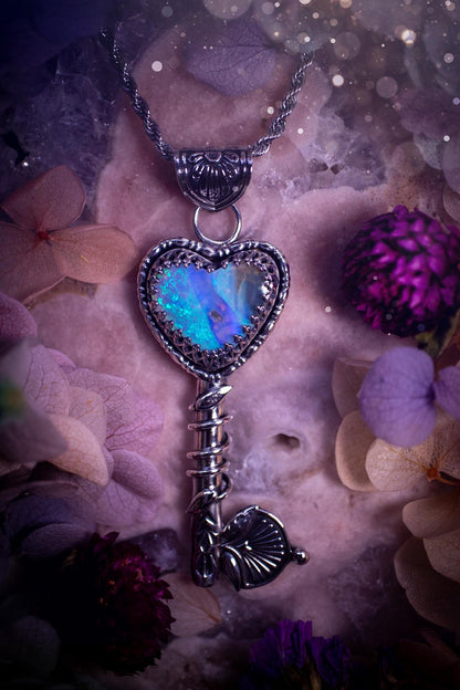 Beautiful and bespoke, Australian Opal, key to my heart pendant necklace. This really unique, fine and sterling silver pendant has been handmade and is a one off design. Featuring a stunning and sparkly Australian opal full of blues, greens and purple as the focus point of this piece. The pendant is in a key design with medieval bail, and leaf with vine features. A lovely piece for any crystal and jewellery collector. This piece gives fairy, love and rustic vibes.
