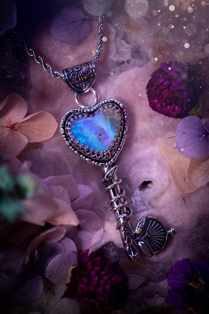 Beautiful and bespoke, Australian Opal, key to my heart pendant necklace. This really unique, fine and sterling silver pendant has been handmade and is a one off design. Featuring a stunning and sparkly Australian opal full of blues, greens and purple as the focus point of this piece. The pendant is in a key design with medieval bail, and leaf with vine features. A lovely piece for any crystal and jewellery collector. This piece gives fairy, love and rustic vibes.