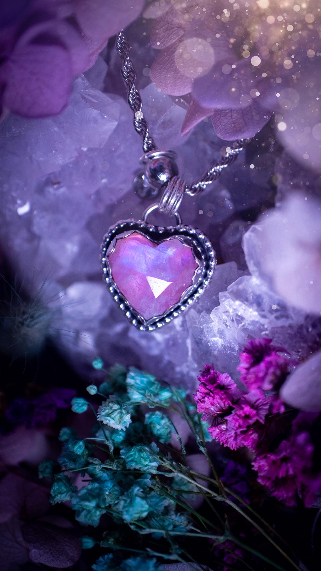 Handmade and bespoke, pink rainbow moonstone heart, sterling silver pendant necklace. This lovely pendant feature a very high quality rainbow moonstone that is full of gorgeous pink and blue flash. This unusual pink colour has been created by using materials under the stone so the pink hue shines through with the iridescence of the moonstone. Made from fine and sterling silver. An ideal piece for any crystal and jewellery lover. Moonstone is the birthstone for June. Unique gothic jewellery