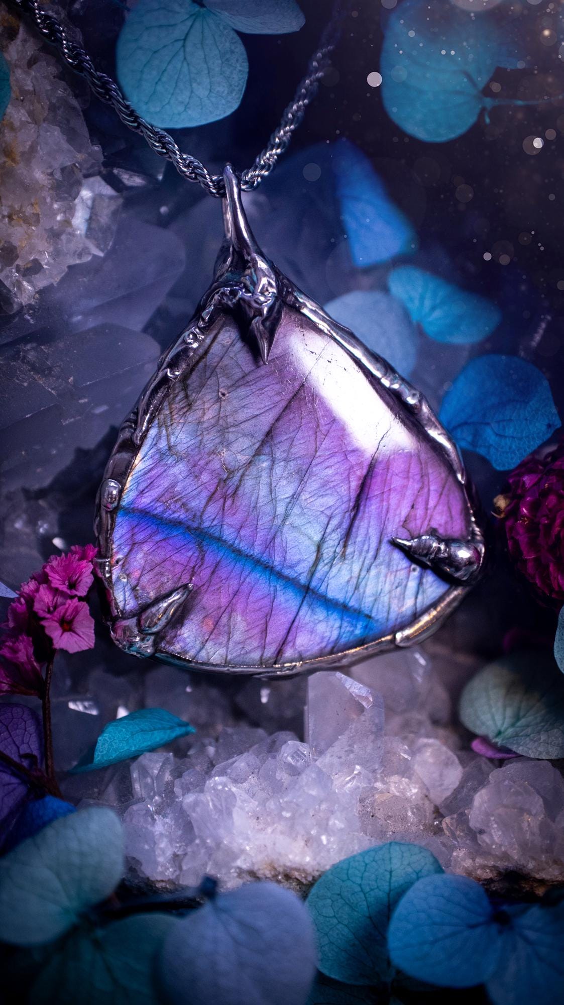 Beautifully handmade and bespoke, purple labradorite, soft soldered pendant necklace. This dainty labradorite pendant has been crafted using the soft solder method, also known as the tiffany technique. The crystal has a bezel of lead free soft solder which contains small parts of silver that allows for oxidisation and a high lustre polish. This labradorite is full of beautiful pinks, purples and has a lovely flash. One off, gothic and witchy jewellery with little claws on the bezel.