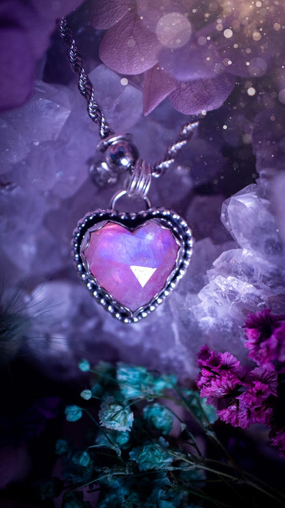 Handmade and bespoke, pink rainbow moonstone heart, sterling silver pendant necklace. This lovely pendant feature a very high quality rainbow moonstone that is full of gorgeous pink and blue flash. This unusual pink colour has been created by using materials under the stone so the pink hue shines through with the iridescence of the moonstone. Made from fine and sterling silver. An ideal piece for any crystal and jewellery lover. Moonstone is the birthstone for June. Unique gothic jewellery
