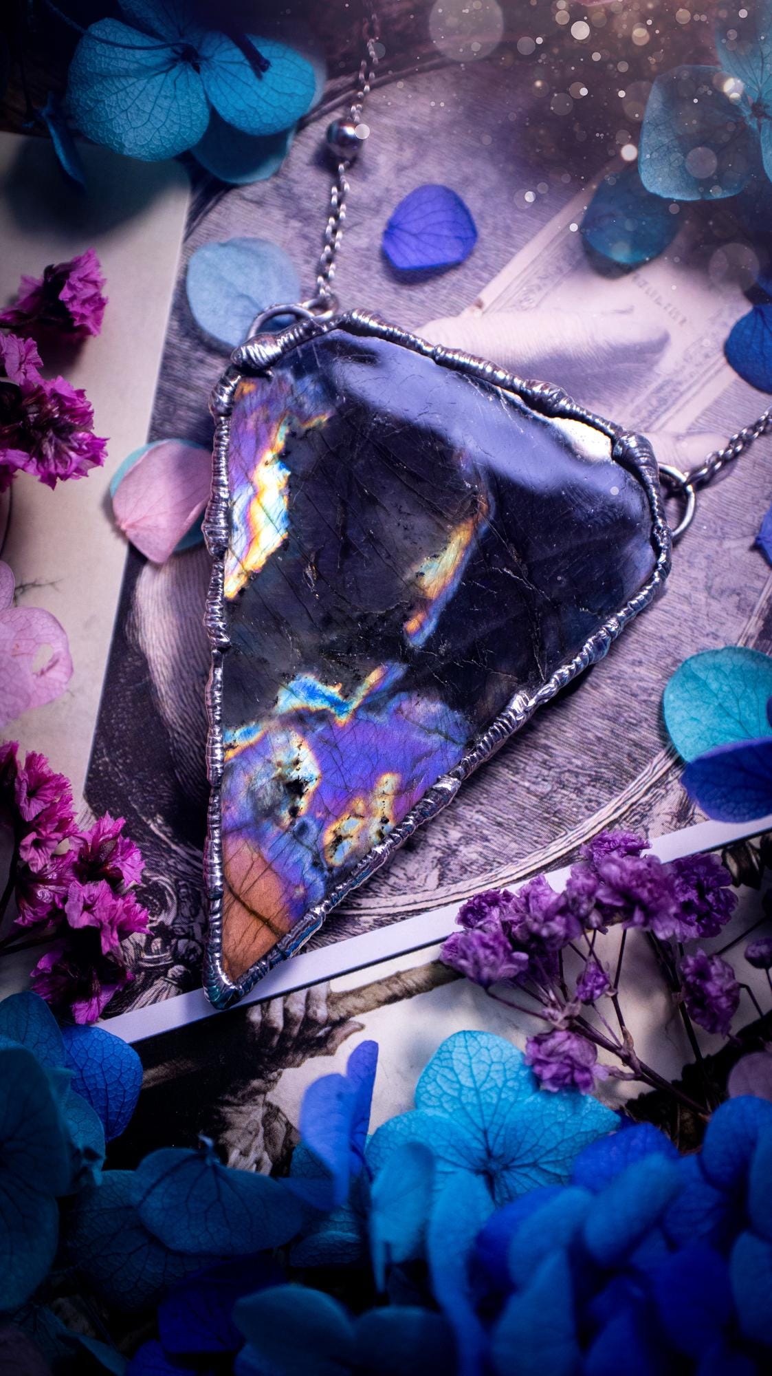 Beautiful and bold, soft soldered, large and very unique Labradorite pendant necklace. This pendant necklace has been handmade using the soft solder method, using lead free solder that contains silver and polished to a high lustre. Featuring a large, very pretty statement Labradorite crystal that is full of beautiful purples, pinks, blacks and orange, with different flashes from different angles. This piece would but suitable for anyone who loves jewellery, crystals, and a gothic aesthetic.