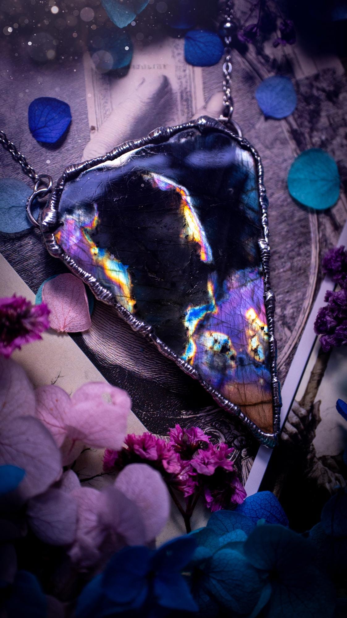 Beautiful and bold, soft soldered, large and very unique Labradorite pendant necklace. This pendant necklace has been handmade using the soft solder method, using lead free solder that contains silver and polished to a high lustre. Featuring a large, very pretty statement Labradorite crystal that is full of beautiful purples, pinks, blacks and orange, with different flashes from different angles. This piece would but suitable for anyone who loves jewellery, crystals, and a gothic aesthetic.