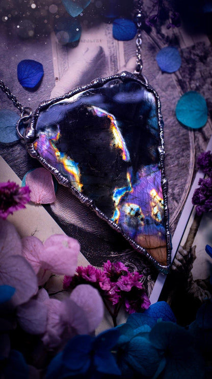 Beautiful and bold, soft soldered, large and very unique Labradorite pendant necklace. This pendant necklace has been handmade using the soft solder method, using lead free solder that contains silver and polished to a high lustre. Featuring a large, very pretty statement Labradorite crystal that is full of beautiful purples, pinks, blacks and orange, with different flashes from different angles. This piece would but suitable for anyone who loves jewellery, crystals, and a gothic aesthetic.