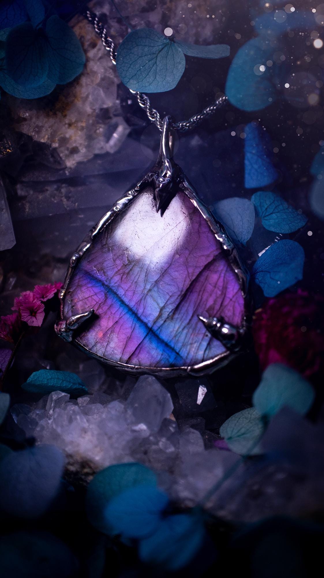 Beautifully handmade and bespoke, purple labradorite, soft soldered pendant necklace. This dainty labradorite pendant has been crafted using the soft solder method, also known as the tiffany technique. The crystal has a bezel of lead free soft solder which contains small parts of silver that allows for oxidisation and a high lustre polish. This labradorite is full of beautiful pinks, purples and has a lovely flash. One off, gothic and witchy jewellery with little claws on the bezel.