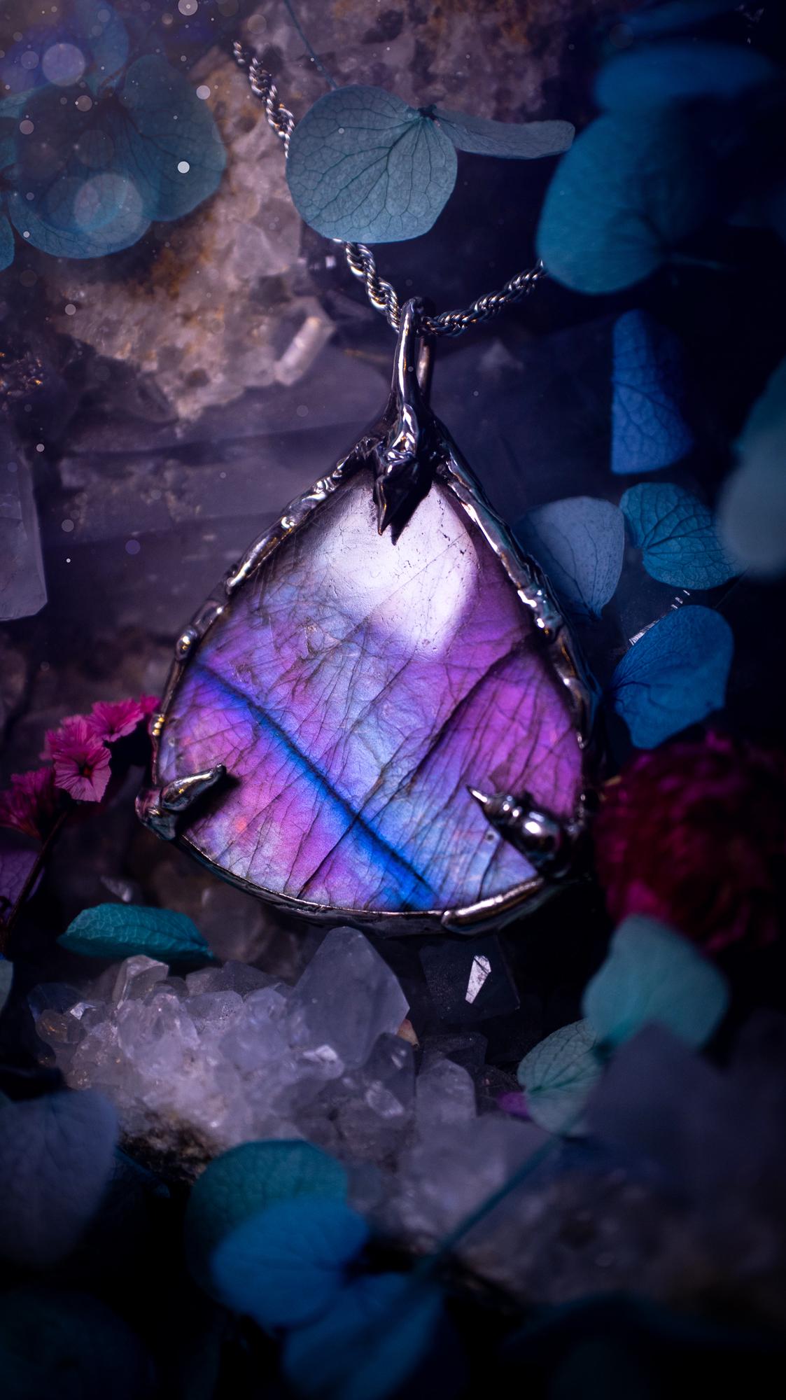 Beautifully handmade and bespoke, purple labradorite, soft soldered pendant necklace. This dainty labradorite pendant has been crafted using the soft solder method, also known as the tiffany technique. The crystal has a bezel of lead free soft solder which contains small parts of silver that allows for oxidisation and a high lustre polish. This labradorite is full of beautiful pinks, purples and has a lovely flash. One off, gothic and witchy jewellery with little claws on the bezel.