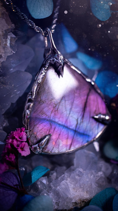 Beautifully handmade and bespoke, purple labradorite, soft soldered pendant necklace. This dainty labradorite pendant has been crafted using the soft solder method, also known as the tiffany technique. The crystal has a bezel of lead free soft solder which contains small parts of silver that allows for oxidisation and a high lustre polish. This labradorite is full of beautiful pinks, purples and has a lovely flash. One off, gothic and witchy jewellery with little claws on the bezel.