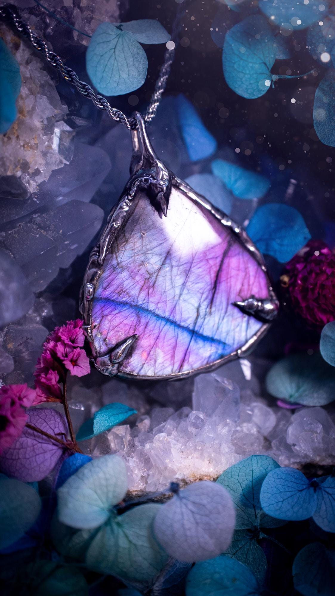 Beautifully handmade and bespoke, purple labradorite, soft soldered pendant necklace. This dainty labradorite pendant has been crafted using the soft solder method, also known as the tiffany technique. The crystal has a bezel of lead free soft solder which contains small parts of silver that allows for oxidisation and a high lustre polish. This labradorite is full of beautiful pinks, purples and has a lovely flash. One off, gothic and witchy jewellery with little claws on the bezel.