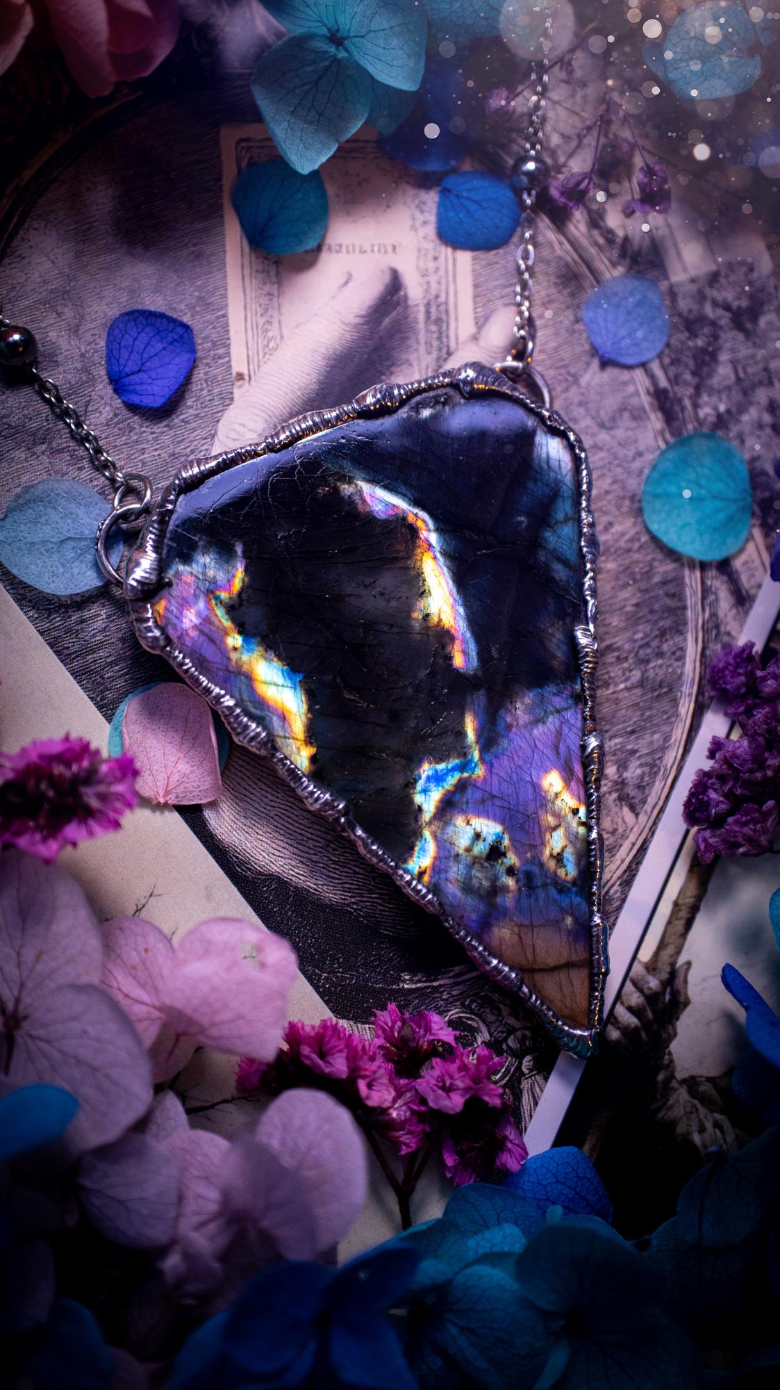 Beautiful and bold, soft soldered, large and very unique Labradorite pendant necklace. This pendant necklace has been handmade using the soft solder method, using lead free solder that contains silver and polished to a high lustre. Featuring a large, very pretty statement Labradorite crystal that is full of beautiful purples, pinks, blacks and orange, with different flashes from different angles. This piece would but suitable for anyone who loves jewellery, crystals, and a gothic aesthetic.