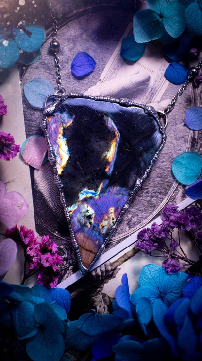 Beautiful and bold, soft soldered, large and very unique Labradorite pendant necklace. This pendant necklace has been handmade using the soft solder method, using lead free solder that contains silver and polished to a high lustre. Featuring a large, very pretty statement Labradorite crystal that is full of beautiful purples, pinks, blacks and orange, with different flashes from different angles. This piece would but suitable for anyone who loves jewellery, crystals, and a gothic aesthetic.