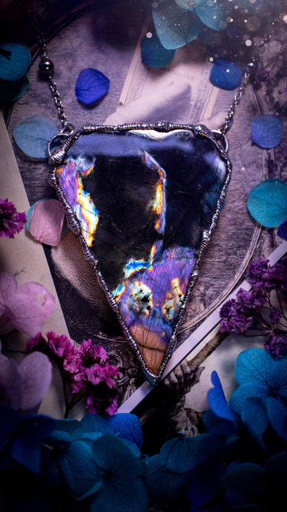 Beautiful and bold, soft soldered, large and very unique Labradorite pendant necklace. This pendant necklace has been handmade using the soft solder method, using lead free solder that contains silver and polished to a high lustre. Featuring a large, very pretty statement Labradorite crystal that is full of beautiful purples, pinks, blacks and orange, with different flashes from different angles. This piece would but suitable for anyone who loves jewellery, crystals, and a gothic aesthetic.