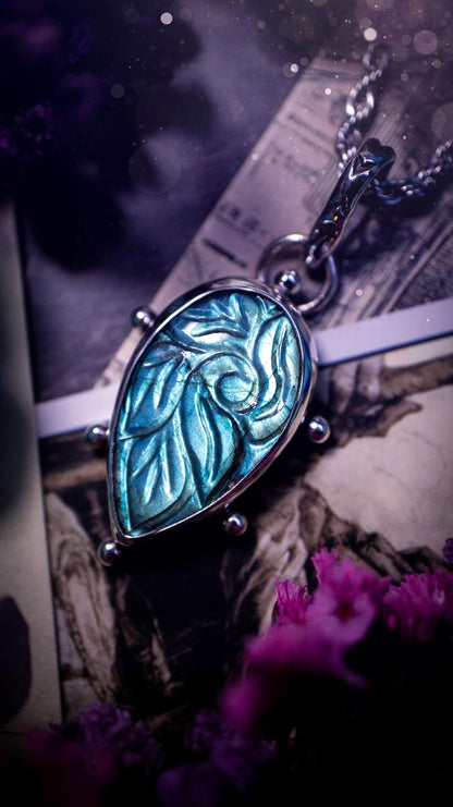 Beautifully handmade, green and blue, hand carved, labradorite crystal pendant necklace. This one of a kind necklace features a beautiful, flashy blue and green labradorite that has a hand carved pattern on its surface. Handcrafted using a mix of fine and sterling silver, with pretty little ball accents and a stamped bail. This cute little piece is ideal for anyone who loves crystals and jewellery. A one off piece with no other being the same, ideal for gifting for any occasion.