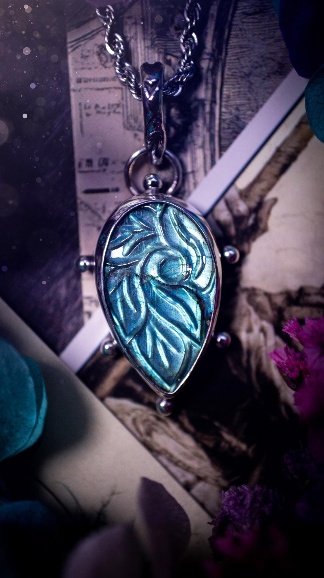 Beautifully handmade, green and blue, hand carved, labradorite crystal pendant necklace. This one of a kind necklace features a beautiful, flashy blue and green labradorite that has a hand carved pattern on its surface. Handcrafted using a mix of fine and sterling silver, with pretty little ball accents and a stamped bail. This cute little piece is ideal for anyone who loves crystals and jewellery. A one off piece with no other being the same, ideal for gifting for any occasion.