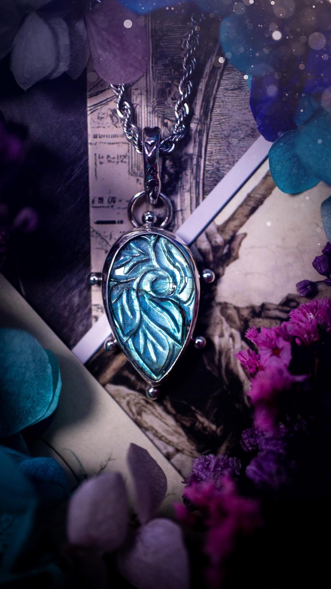 Beautifully handmade, green and blue, hand carved, labradorite crystal pendant necklace. This one of a kind necklace features a beautiful, flashy blue and green labradorite that has a hand carved pattern on its surface. Handcrafted using a mix of fine and sterling silver, with pretty little ball accents and a stamped bail. This cute little piece is ideal for anyone who loves crystals and jewellery. A one off piece with no other being the same, ideal for gifting for any occasion.