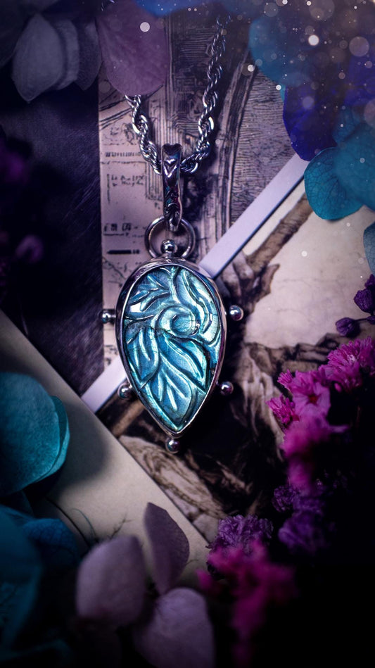 Beautifully handmade, green and blue, hand carved, labradorite crystal pendant necklace. This one of a kind necklace features a beautiful, flashy blue and green labradorite that has a hand carved pattern on its surface. Handcrafted using a mix of fine and sterling silver, with pretty little ball accents and a stamped bail. This cute little piece is ideal for anyone who loves crystals and jewellery. A one off piece with no other being the same, ideal for gifting for any occasion.