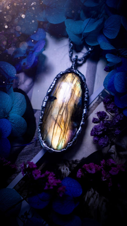 Beautiful, handmade and totally bespoke, orange and yellow, labradorite crystal, pendant necklace. This jewellery piece has been handcrafted using the soft solder method, using lead free solder that contains silver, then oxidised to create a gothic mystical look. Featuring a beautiful multi flash labradorite crystal with the flash shifting from yellow to orange. A lovely piece ideal for anyone who loves crystals and jewellery. This is a one of a kind piece with no other the same, gothic design