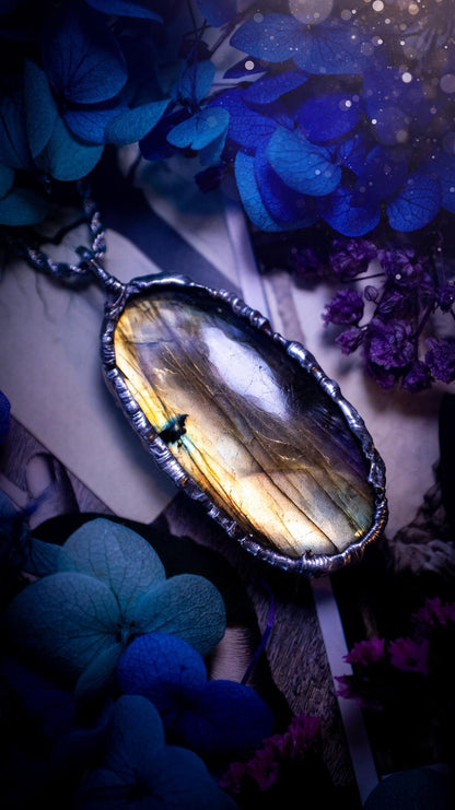 Beautiful, handmade and totally bespoke, orange and yellow, labradorite crystal, pendant necklace. This jewellery piece has been handcrafted using the soft solder method, using lead free solder that contains silver, then oxidised to create a gothic mystical look. Featuring a beautiful multi flash labradorite crystal with the flash shifting from yellow to orange. A lovely piece ideal for anyone who loves crystals and jewellery. This is a one of a kind piece with no other the same, gothic design