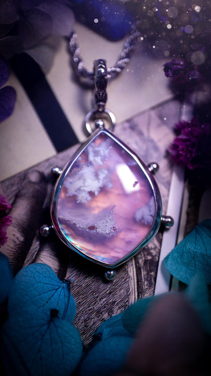 Beautifully handmade, aurora opal doublet and plume agate crystal pendant necklace. This necklace has been made from a mixed of fine and sterling silver. Featuring a stunning and unusual Aurora opal and plume agate doublet that has little tiny druzys, full of beautiful pattern and a glowing pink essence. Around the smooth bezel is some cute little ball details. This piece of jewellery would be ideal for any crystal and jewellery lover how loves unique and alternative pieces! Ideal for gifting