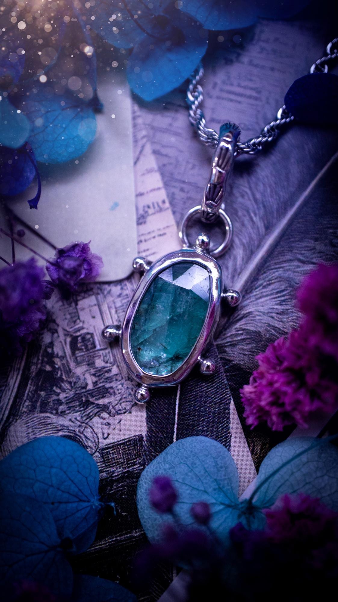 One of a kind, stunning and natural, teal green kyanite, pendant necklace. This pendant has been handcrafted using a mix of fine and sterling silver. Featuring a natural and gorgeous, deep teal green kyanite that has inclusions and rainbows! The stone is rose cut for an extra sparkle. Around the smooth bezel is small ball details, with a bohemian stamped pattern bail. This piece would be ideal for anyone who loves jewellery, crystals or both! Bohemian and hippy jewellery for the soul.