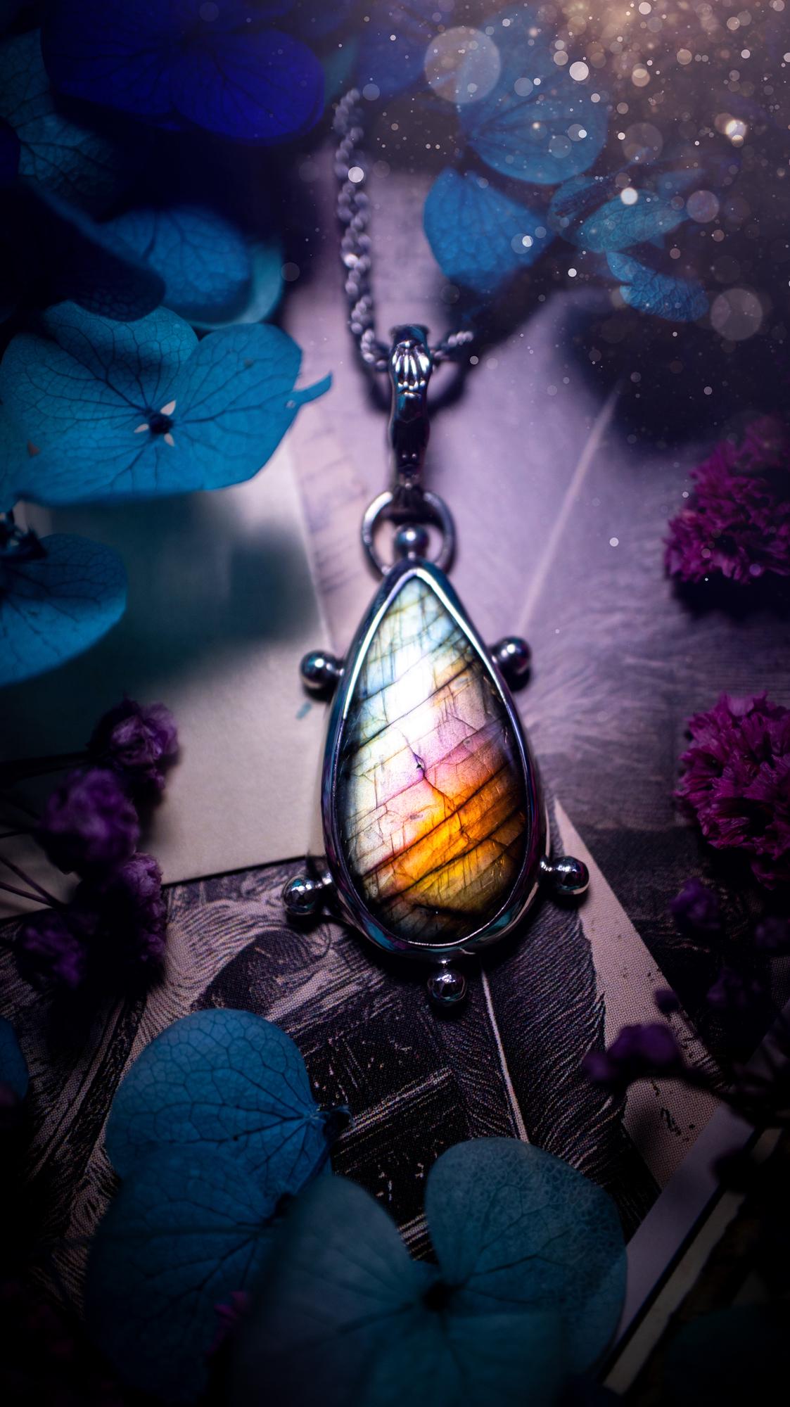 One of a kind and very unique, rainbow labradorite, crystal pendant necklace. This bohemian style pendant necklace has been handcrafted using a mix of fine and sterling silver. Featuring a rare rainbow coloured labradorite that has such a strong intense flash full of beautiful hue. Around the smooth bezel is small silver ball details, and a bohemian stamped pattern bail. This pendant necklace would be ideal for anyone who loves crystal and jewellery. One of pieces of jewellery for the soul.