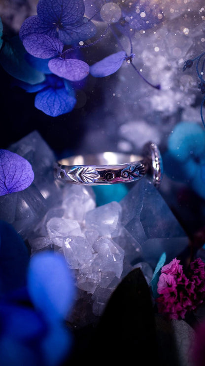 One of a kind and handmade, Australian boulder opal, bohemian ring. This stunning ring has been handcrafted using a mix of fine and sterling silver. Featuring a small, yet totally stunning and vibrant Australian boulder opal full of blues, purples, and green sparkles. Around the smooth bezel is some pretty gallery wire. The ring shank has also been stamped with a bohemian pattern. This one off piece is ideal for any crystal and jewellery lover who is seeking a piece that has no other the same!