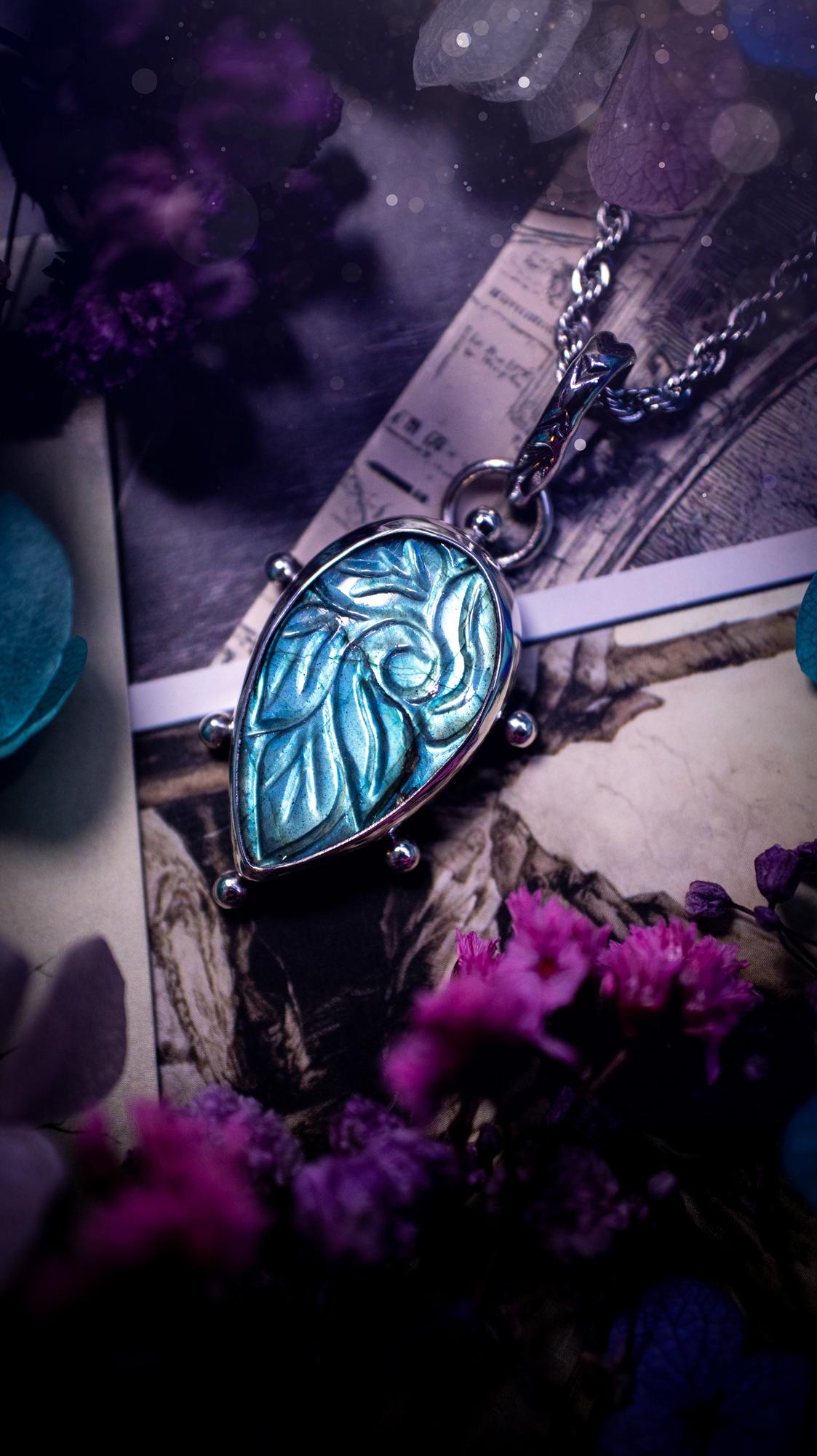 Beautifully handmade, green and blue, hand carved, labradorite crystal pendant necklace. This one of a kind necklace features a beautiful, flashy blue and green labradorite that has a hand carved pattern on its surface. Handcrafted using a mix of fine and sterling silver, with pretty little ball accents and a stamped bail. This cute little piece is ideal for anyone who loves crystals and jewellery. A one off piece with no other being the same, ideal for gifting for any occasion.