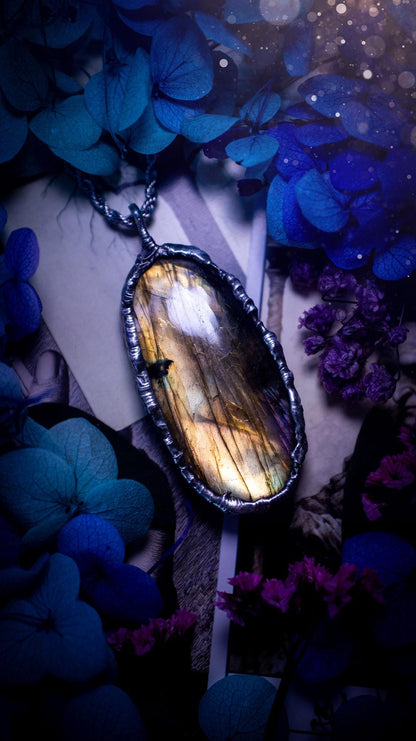 Beautiful, handmade and totally bespoke, orange and yellow, labradorite crystal, pendant necklace. This jewellery piece has been handcrafted using the soft solder method, using lead free solder that contains silver, then oxidised to create a gothic mystical look. Featuring a beautiful multi flash labradorite crystal with the flash shifting from yellow to orange. A lovely piece ideal for anyone who loves crystals and jewellery. This is a one of a kind piece with no other the same, gothic design