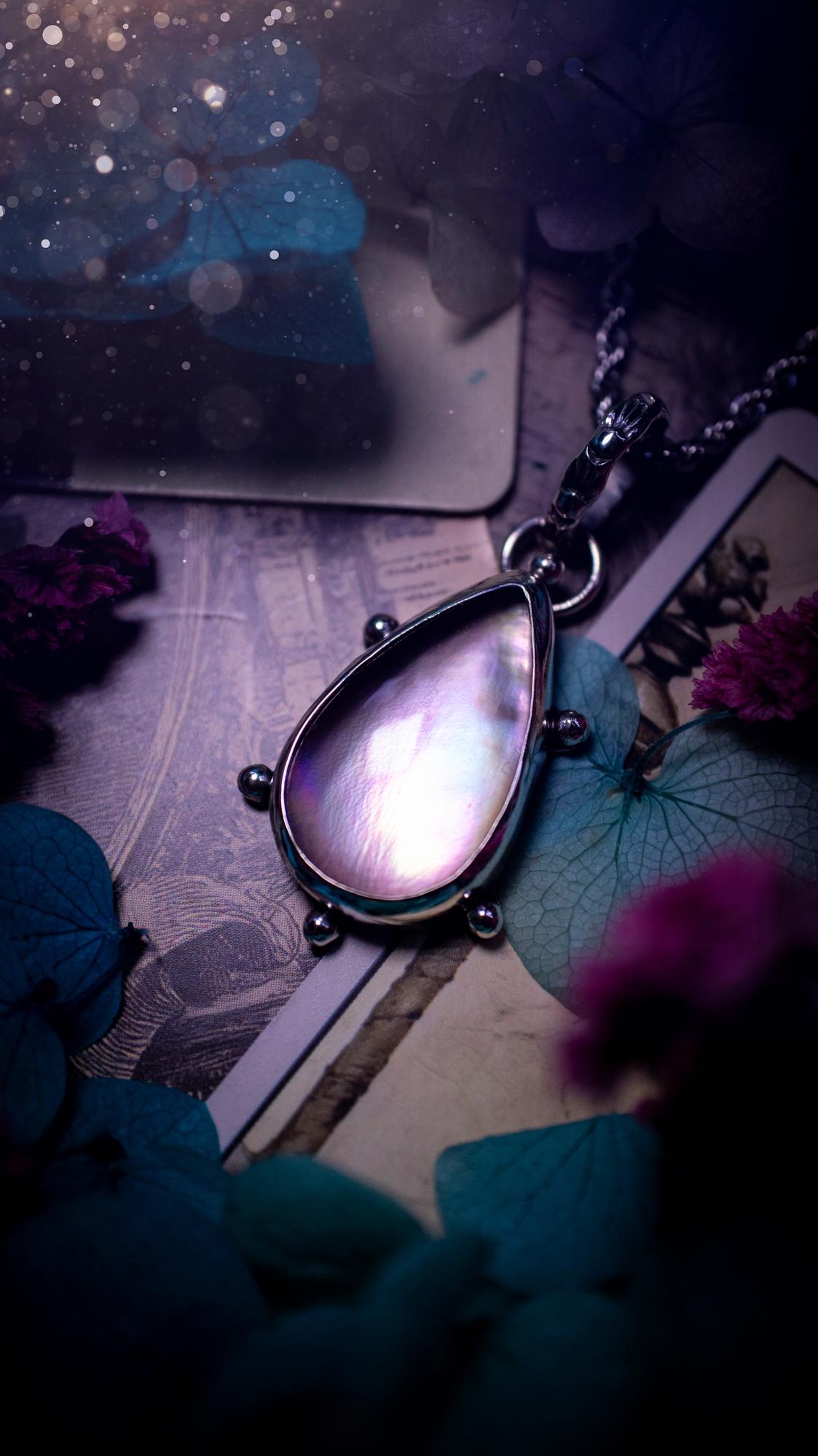 Beautifully handmade, mother of pearl and Himalayan quartz crystal pendant necklace. This necklace has been made from a mixed of fine and sterling silver. Featuring a stunning and high grade mother of pearl and quartz crystal which is full of iridescence and a glowing pink essence. Around the smooth bezel is some cute little ball details. This piece of jewellery would be ideal for any crystal and jewellery lover how loves unique and alternative pieces! Ideal for gifting