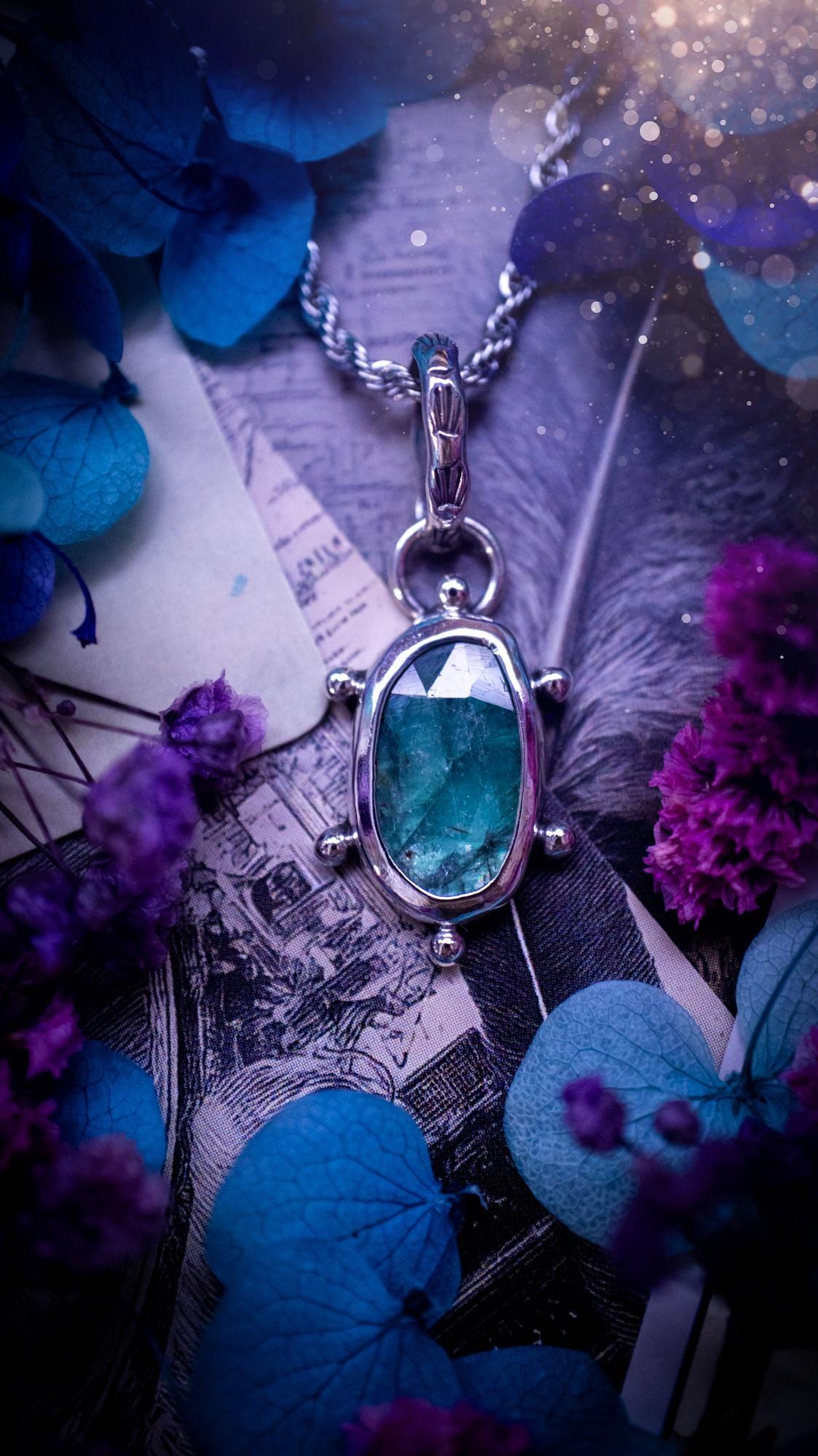 One of a kind, stunning and natural, teal green kyanite, pendant necklace. This pendant has been handcrafted using a mix of fine and sterling silver. Featuring a natural and gorgeous, deep teal green kyanite that has inclusions and rainbows! The stone is rose cut for an extra sparkle. Around the smooth bezel is small ball details, with a bohemian stamped pattern bail. This piece would be ideal for anyone who loves jewellery, crystals or both! Bohemian and hippy jewellery for the soul.