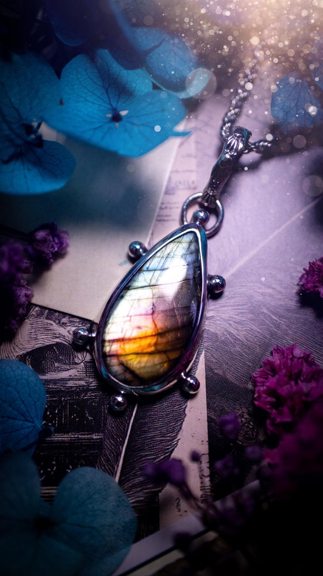 One of a kind and very unique, rainbow labradorite, crystal pendant necklace. This bohemian style pendant necklace has been handcrafted using a mix of fine and sterling silver. Featuring a rare rainbow coloured labradorite that has such a strong intense flash full of beautiful hue. Around the smooth bezel is small silver ball details, and a bohemian stamped pattern bail. This pendant necklace would be ideal for anyone who loves crystal and jewellery. One of pieces of jewellery for the soul.