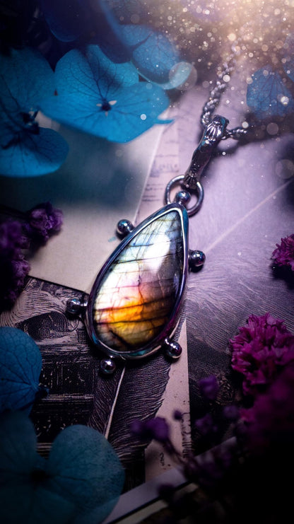 One of a kind and very unique, rainbow labradorite, crystal pendant necklace. This bohemian style pendant necklace has been handcrafted using a mix of fine and sterling silver. Featuring a rare rainbow coloured labradorite that has such a strong intense flash full of beautiful hue. Around the smooth bezel is small silver ball details, and a bohemian stamped pattern bail. This pendant necklace would be ideal for anyone who loves crystal and jewellery. One of pieces of jewellery for the soul.