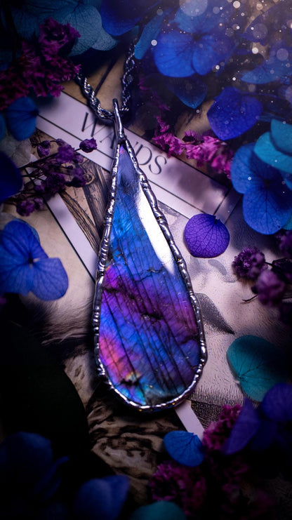 Beautiful and bold, soft soldered, large and very unique Labradorite pendant necklace. This pendant necklace has been handmade using the soft solder method, using lead free solder that contains silver and polished to a high lustre. Featuring a large, very pretty statement Labradorite crystal that is full of beautiful purples, pinks, and blues, with different flashes from different angles. This piece would but suitable for anyone who loves jewellery, crystals, and a gothic aesthetic.