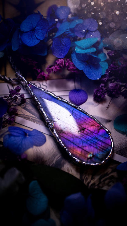 Beautiful and bold, soft soldered, large and very unique Labradorite pendant necklace. This pendant necklace has been handmade using the soft solder method, using lead free solder that contains silver and polished to a high lustre. Featuring a large, very pretty statement Labradorite crystal that is full of beautiful purples, pinks, and blues, with different flashes from different angles. This piece would but suitable for anyone who loves jewellery, crystals, and a gothic aesthetic.