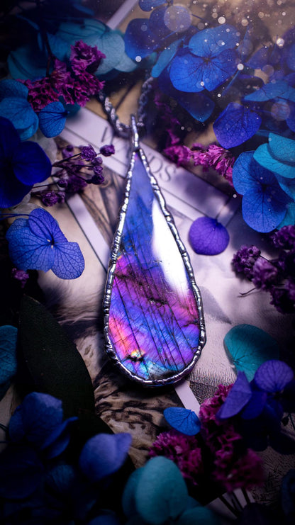 Beautiful and bold, soft soldered, large and very unique Labradorite pendant necklace. This pendant necklace has been handmade using the soft solder method, using lead free solder that contains silver and polished to a high lustre. Featuring a large, very pretty statement Labradorite crystal that is full of beautiful purples, pinks, and blues, with different flashes from different angles. This piece would but suitable for anyone who loves jewellery, crystals, and a gothic aesthetic.