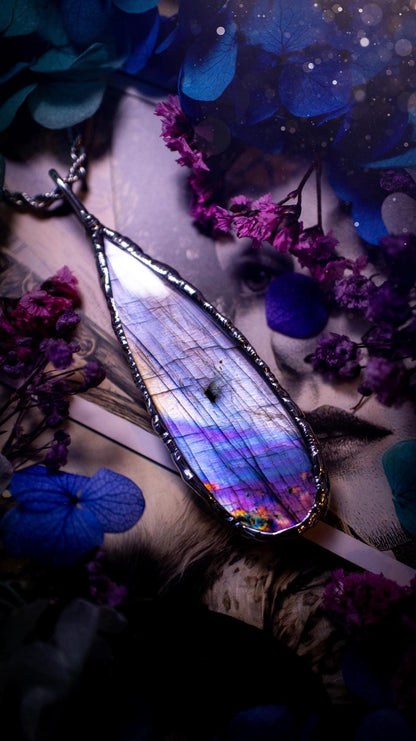 Beautiful and bold, soft soldered, large and very unique Labradorite pendant necklace. This pendant necklace has been handmade using the soft solder method, using lead free solder that contains silver and polished to a high lustre. Featuring a large, very pretty statement Labradorite crystal that is full of beautiful purples, pinks, silver and blues, with different flashes from different angles. This piece would but suitable for anyone who loves jewellery, crystals, and a gothic aesthetic.