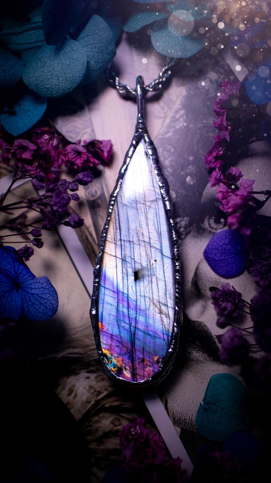 Beautiful and bold, soft soldered, large and very unique Labradorite pendant necklace. This pendant necklace has been handmade using the soft solder method, using lead free solder that contains silver and polished to a high lustre. Featuring a large, very pretty statement Labradorite crystal that is full of beautiful purples, pinks, silver and blues, with different flashes from different angles. This piece would but suitable for anyone who loves jewellery, crystals, and a gothic aesthetic.
