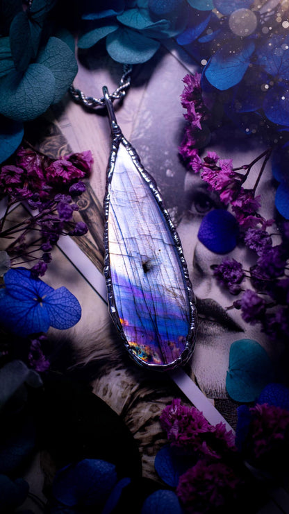 Beautiful and bold, soft soldered, large and very unique Labradorite pendant necklace. This pendant necklace has been handmade using the soft solder method, using lead free solder that contains silver and polished to a high lustre. Featuring a large, very pretty statement Labradorite crystal that is full of beautiful purples, pinks, silver and blues, with different flashes from different angles. This piece would but suitable for anyone who loves jewellery, crystals, and a gothic aesthetic.