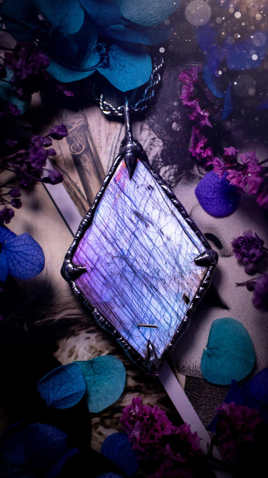 One of a kind, purple pink and blue, soft soldered, Labradorite crystal pendant necklace. This pendant has been made with love and care, handcrafted using the tiffany technique, also known as soft solder method. The crystal has a bezel of solder that contains various metals including silver and is hypoallergenic. Featuring a stunning, natural and unique coloured Labradorite crystal. This jewellery piece is ideal for gifting and for anyone who loves crystals and jewellery with a gothic vibe.