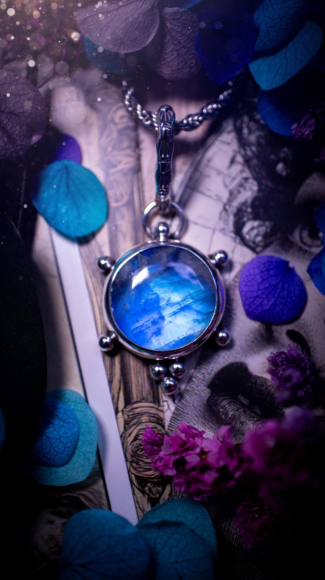 Beautifully handmade, high grade, rainbow moonstone, crystal pendant necklace. This one of a kind necklace features a beautiful, very high grade flashy blue rainbow moonstone. Handcrafted using a mix of fine and sterling silver, with pretty little ball accents and a stamped patterned bail. This cute little jewellery piece is ideal for anyone who loves crystals and jewellery. A one off piece with no other being the same, ideal for gifting for any occasion.