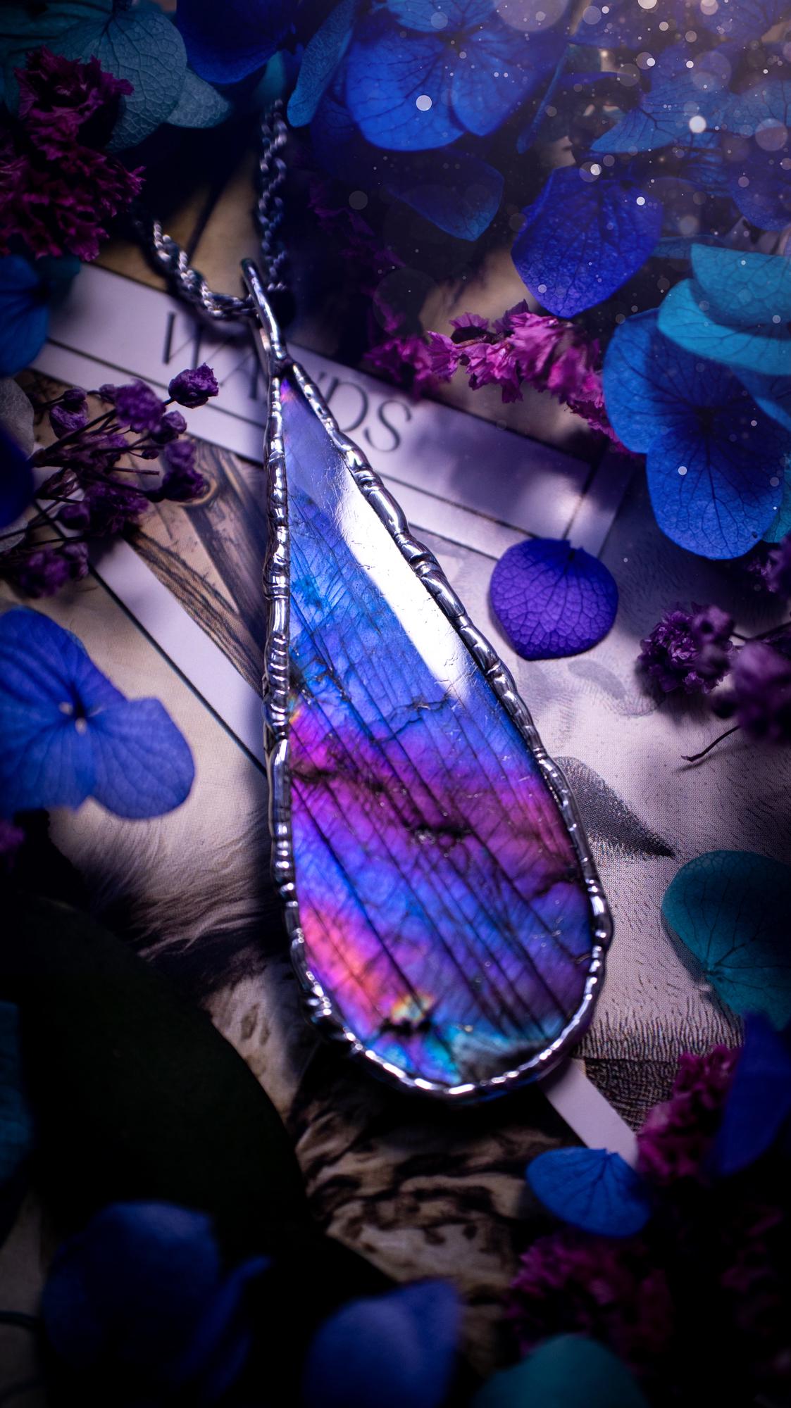 Beautiful and bold, soft soldered, large and very unique Labradorite pendant necklace. This pendant necklace has been handmade using the soft solder method, using lead free solder that contains silver and polished to a high lustre. Featuring a large, very pretty statement Labradorite crystal that is full of beautiful purples, pinks, and blues, with different flashes from different angles. This piece would but suitable for anyone who loves jewellery, crystals, and a gothic aesthetic.