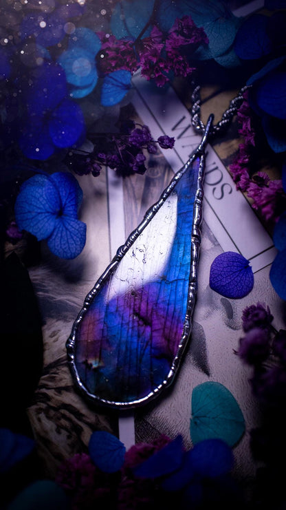 Beautiful and bold, soft soldered, large and very unique Labradorite pendant necklace. This pendant necklace has been handmade using the soft solder method, using lead free solder that contains silver and polished to a high lustre. Featuring a large, very pretty statement Labradorite crystal that is full of beautiful purples, pinks, and blues, with different flashes from different angles. This piece would but suitable for anyone who loves jewellery, crystals, and a gothic aesthetic.