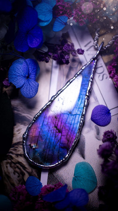 Beautiful and bold, soft soldered, large and very unique Labradorite pendant necklace. This pendant necklace has been handmade using the soft solder method, using lead free solder that contains silver and polished to a high lustre. Featuring a large, very pretty statement Labradorite crystal that is full of beautiful purples, pinks, and blues, with different flashes from different angles. This piece would but suitable for anyone who loves jewellery, crystals, and a gothic aesthetic.
