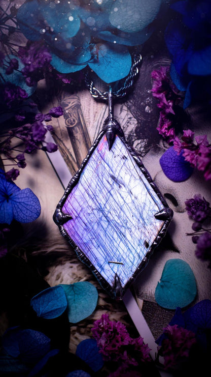 One of a kind, purple pink and blue, soft soldered, Labradorite crystal pendant necklace. This pendant has been made with love and care, handcrafted using the tiffany technique, also known as soft solder method. The crystal has a bezel of solder that contains various metals including silver and is hypoallergenic. Featuring a stunning, natural and unique coloured Labradorite crystal. This jewellery piece is ideal for gifting and for anyone who loves crystals and jewellery with a gothic vibe.