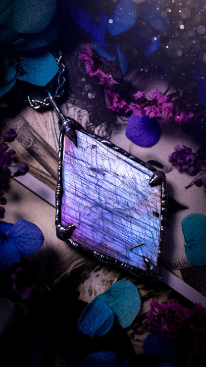 One of a kind, purple pink and blue, soft soldered, Labradorite crystal pendant necklace. This pendant has been made with love and care, handcrafted using the tiffany technique, also known as soft solder method. The crystal has a bezel of solder that contains various metals including silver and is hypoallergenic. Featuring a stunning, natural and unique coloured Labradorite crystal. This jewellery piece is ideal for gifting and for anyone who loves crystals and jewellery with a gothic vibe.