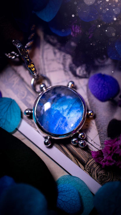 Beautifully handmade, high grade, rainbow moonstone, crystal pendant necklace. This one of a kind necklace features a beautiful, very high grade flashy blue rainbow moonstone. Handcrafted using a mix of fine and sterling silver, with pretty little ball accents and a stamped patterned bail. This cute little jewellery piece is ideal for anyone who loves crystals and jewellery. A one off piece with no other being the same, ideal for gifting for any occasion.