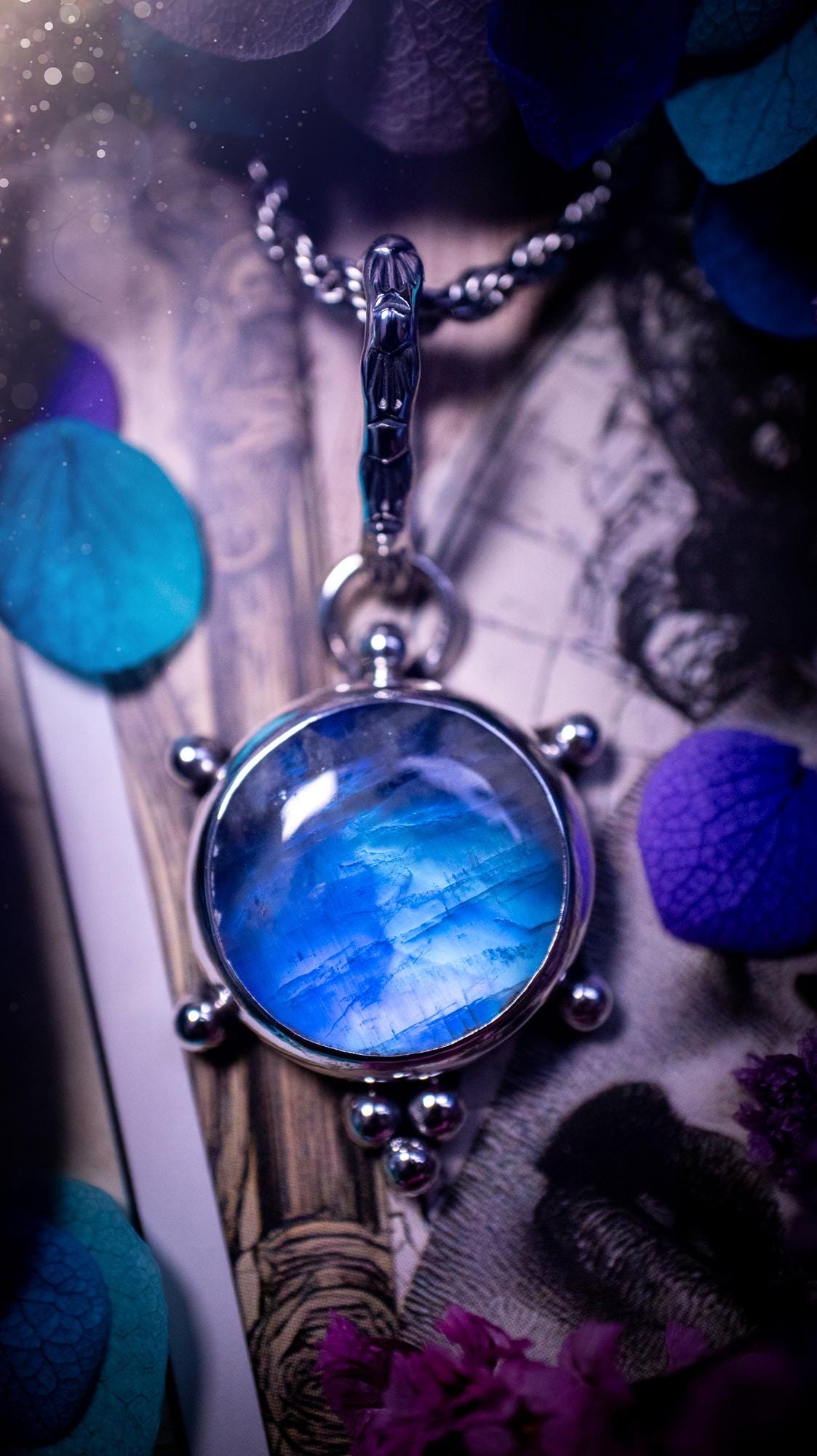Beautifully handmade, high grade, rainbow moonstone, crystal pendant necklace. This one of a kind necklace features a beautiful, very high grade flashy blue rainbow moonstone. Handcrafted using a mix of fine and sterling silver, with pretty little ball accents and a stamped patterned bail. This cute little jewellery piece is ideal for anyone who loves crystals and jewellery. A one off piece with no other being the same, ideal for gifting for any occasion.