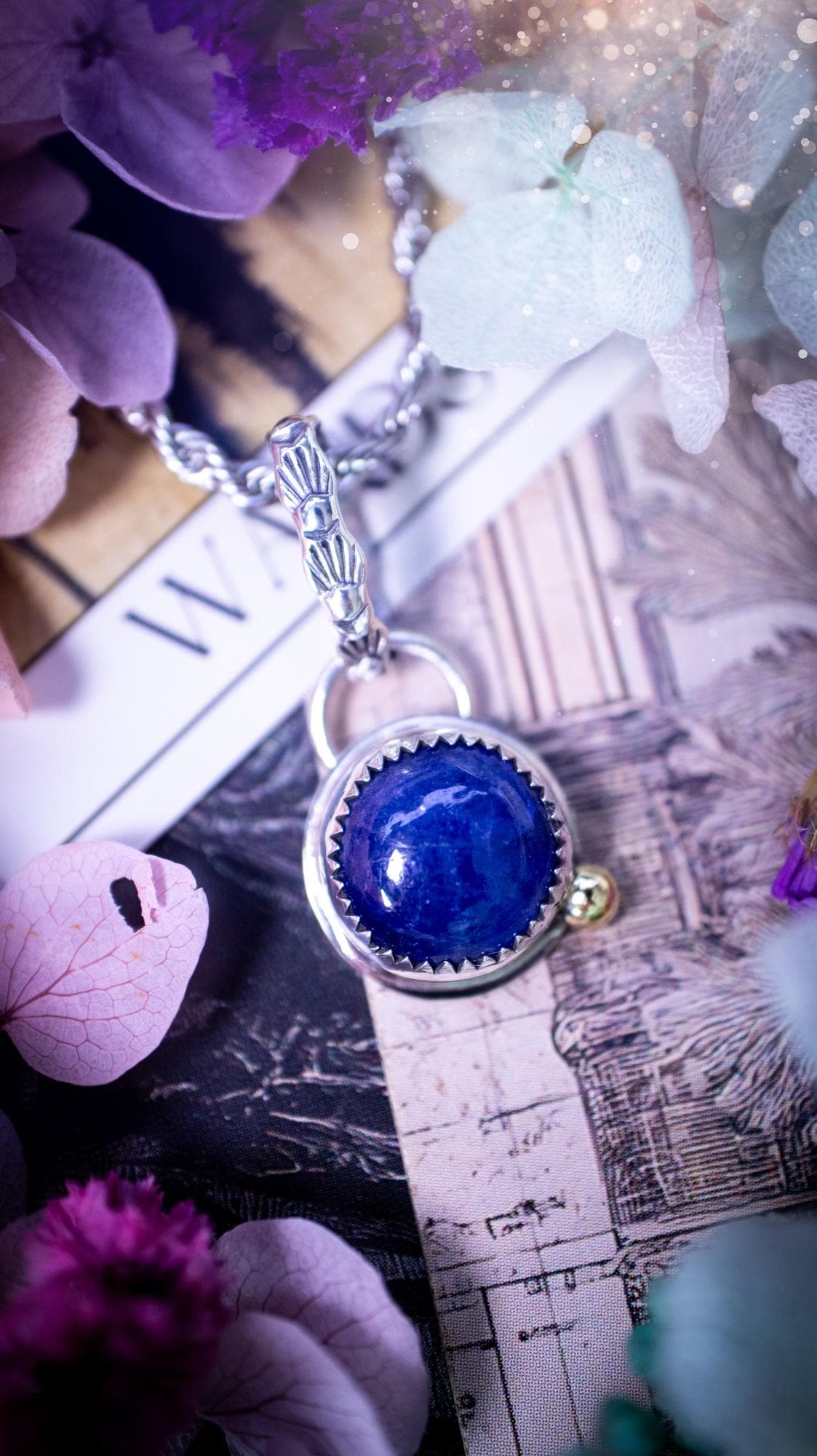 Handmade tanzanite pendant set in sterling silver with a high polished finish. The natural tanzanite gemstone displays rich blue violet tones with beautiful depth and shimmer in the light. Finished with a polished brass golden ball accent and a decorative patterned bail. Bohemian, gothic and witchy style crystal jewellery, perfect as a meaningful gift or elegant everyday statement piece. Tanzanite is the birthstone for December.