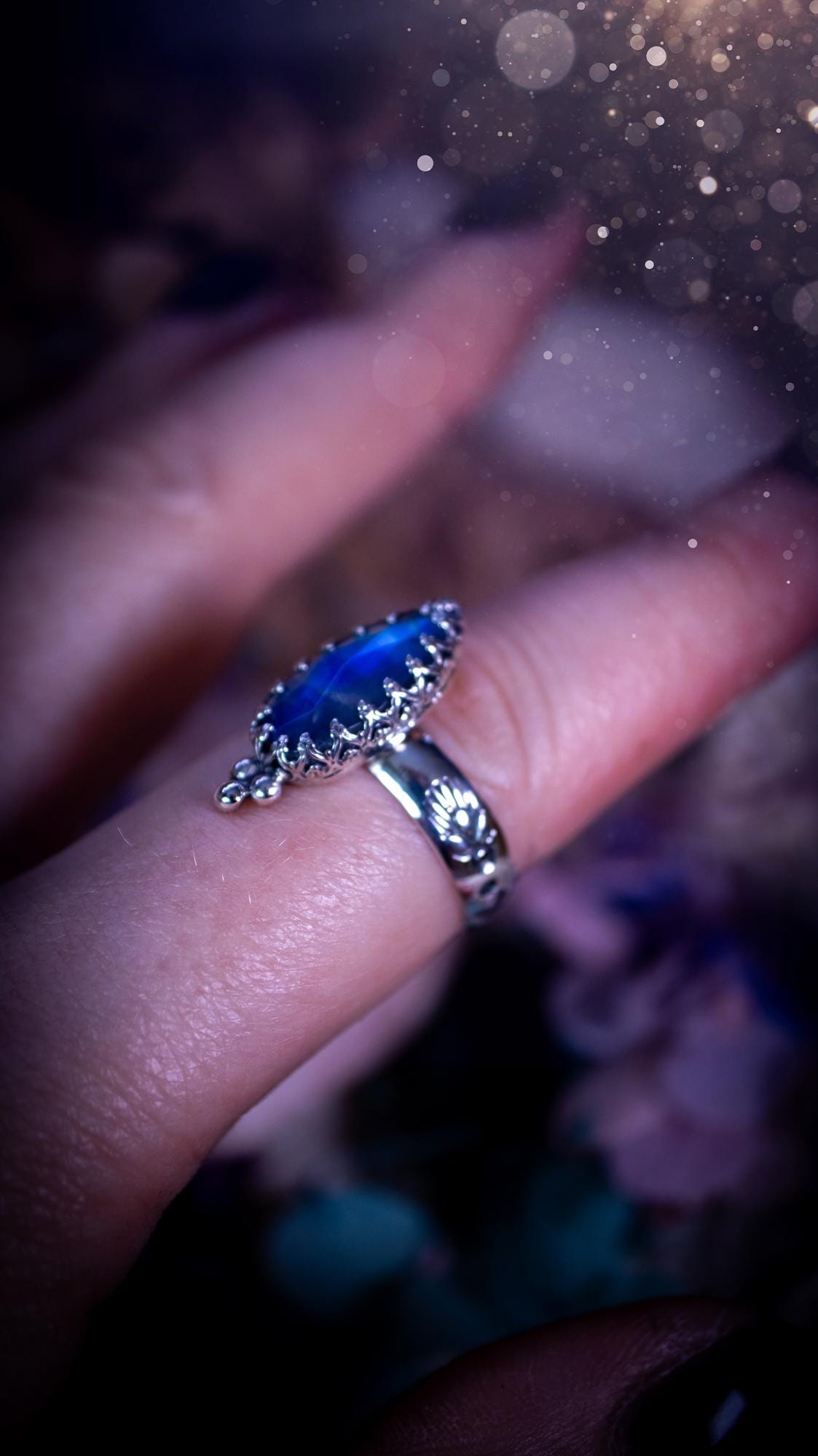 Beautiful and completely handmade, rainbow moonstone, gothic style mini statement stacker ring. This ring has been handcrafted using a mix of fine and sterling silver. Featuring a beautiful, high grade rainbow moonstone. The crystal is rose cut for a sparkle and is full of blue flash! Around the moonstone is a gothic gallery wire bezel, and little silver ball accents. The ring shank has a one of a kind stamped pattern. Ideal for birthdays and special occasions. Gothic and witchy jewellery.