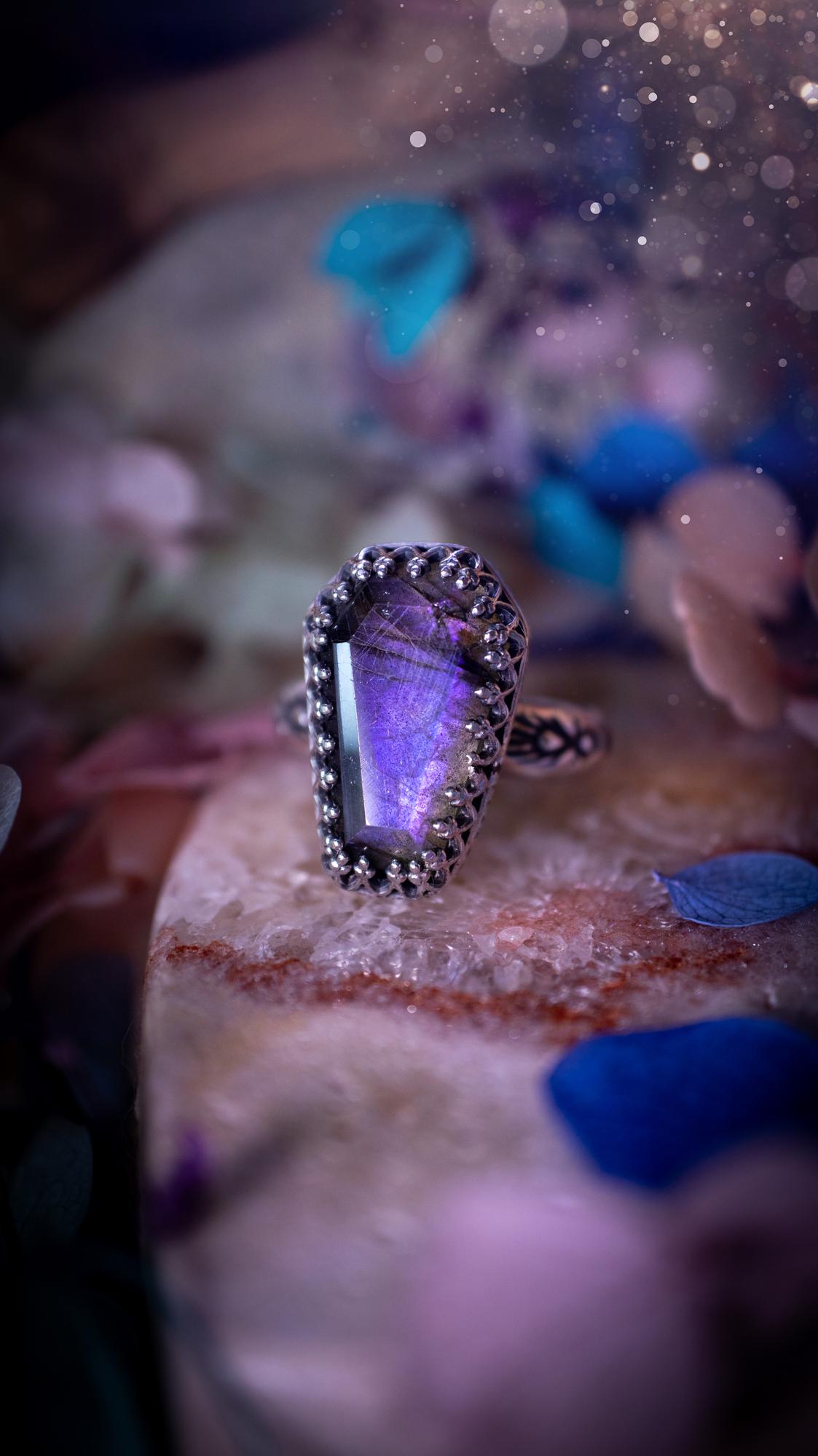 Beautiful and completely handmade, purple labradorite coffin, gothic style, mini statement stacker ring. This ring has been handcrafted using a mix of fine and sterling silver. Featuring a beautiful, purple labradorite gemstone. The crystal is step cut for a sparkle and is full of flash! Around the labradorite is a gothic gallery wire bezel for extra gothic vibes. The ring shank has a one of a kind stamped pattern. Ideal for birthdays and special occasions. Gothic and witchy jewellery.