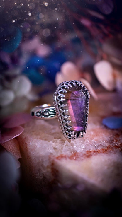 Beautiful and completely handmade, purple labradorite coffin, gothic style, mini statement stacker ring. This ring has been handcrafted using a mix of fine and sterling silver. Featuring a beautiful, purple labradorite gemstone. The crystal is step cut for a sparkle and is full of flash! Around the labradorite is a gothic gallery wire bezel for extra gothic vibes. The ring shank has a one of a kind stamped pattern. Ideal for birthdays and special occasions. Gothic and witchy jewellery.